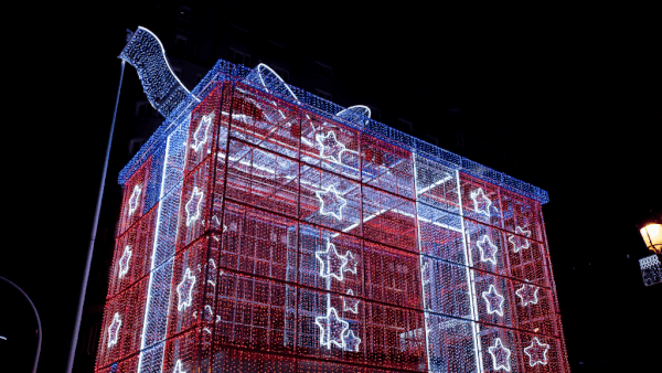 Giant gift box lit up with red, white and blue Christmas lights in Vigo